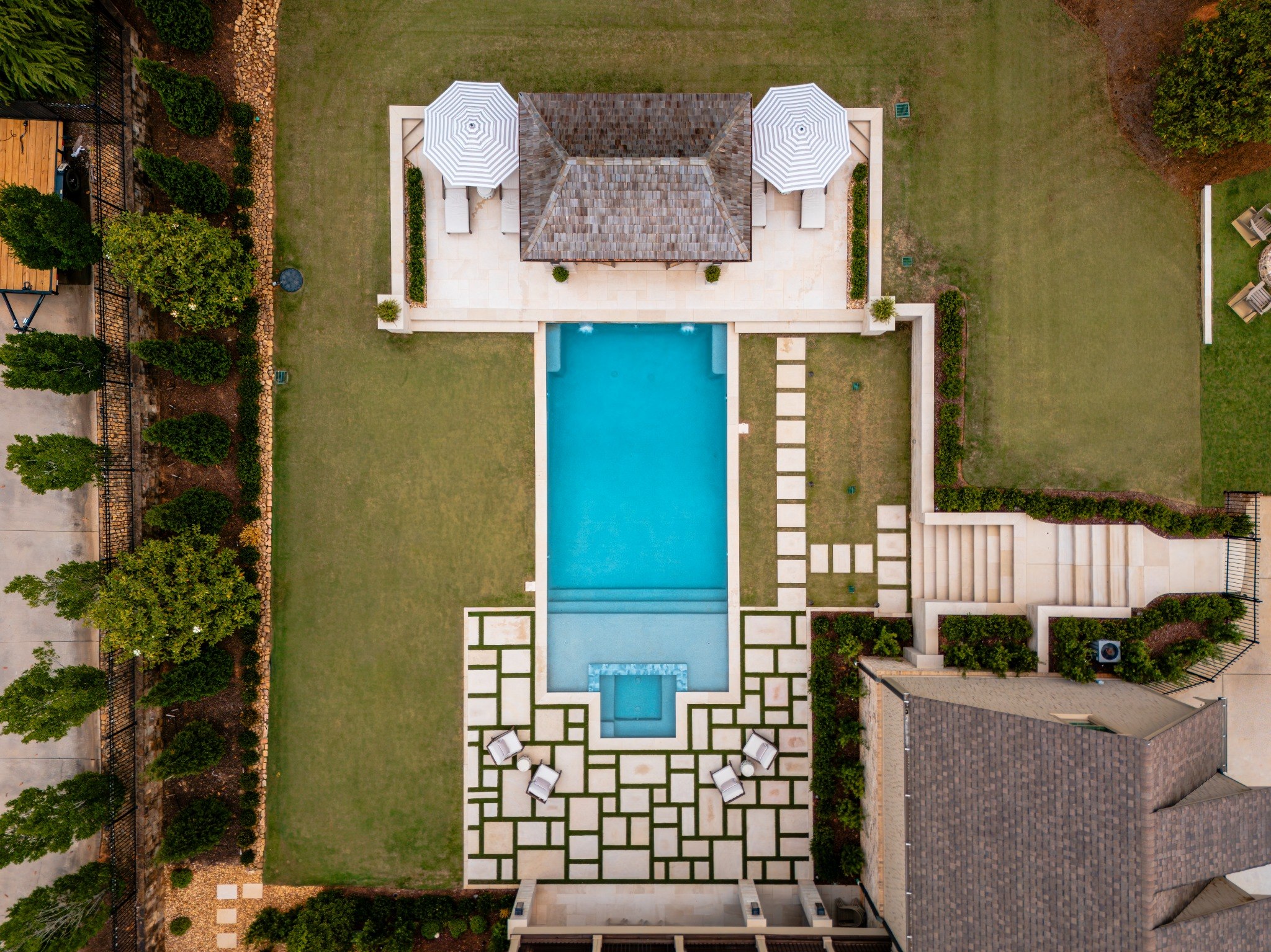 Straight-down aerial of geometric pool and outdoor space