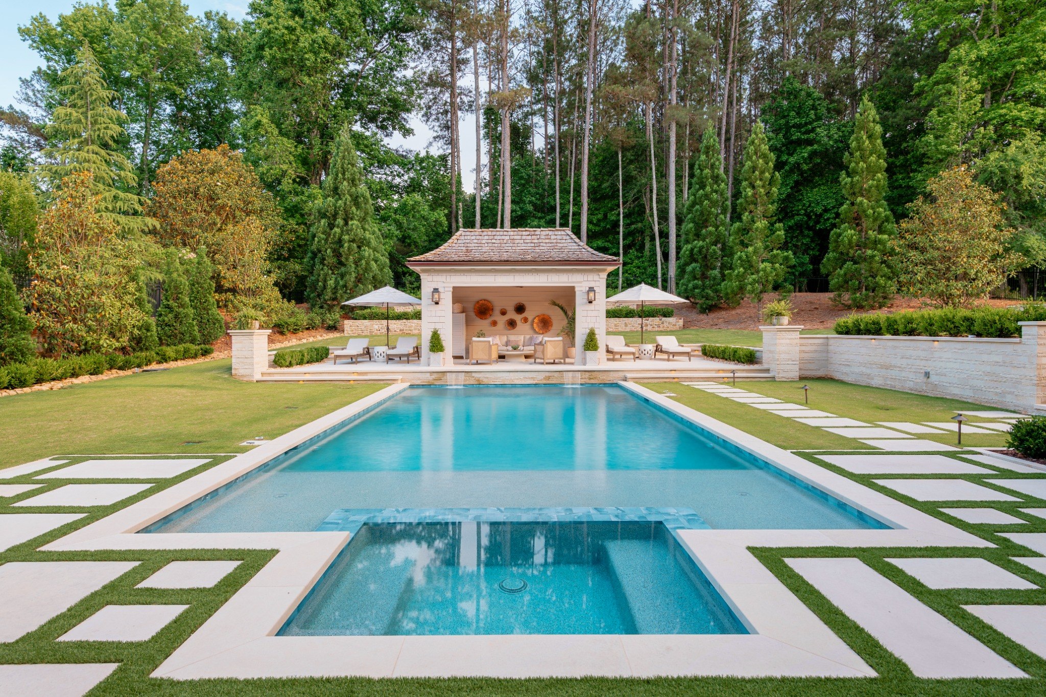 Symmetrical daytime pool and pavilion