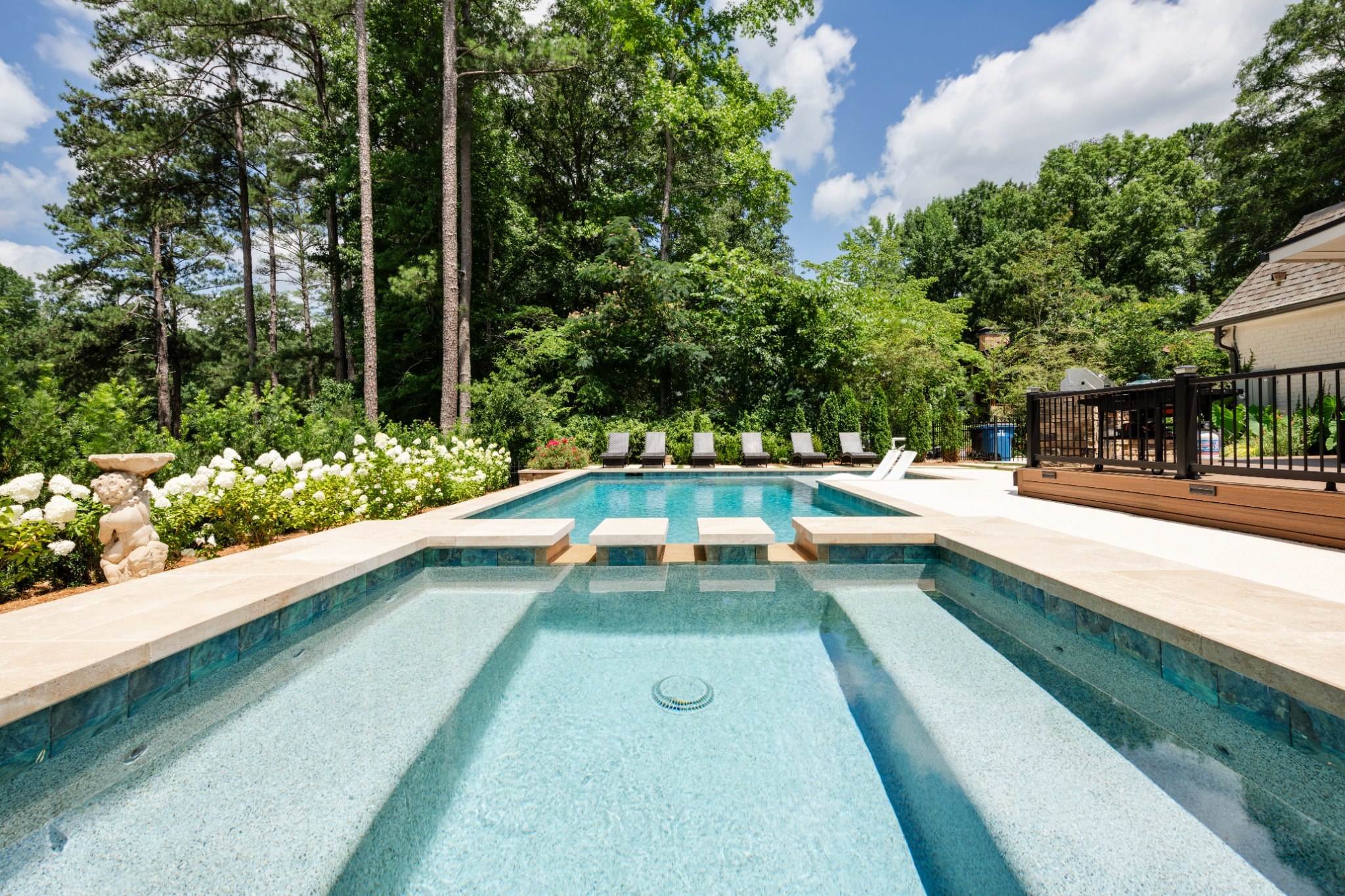 Outdoor seating area overlooking pool and spa