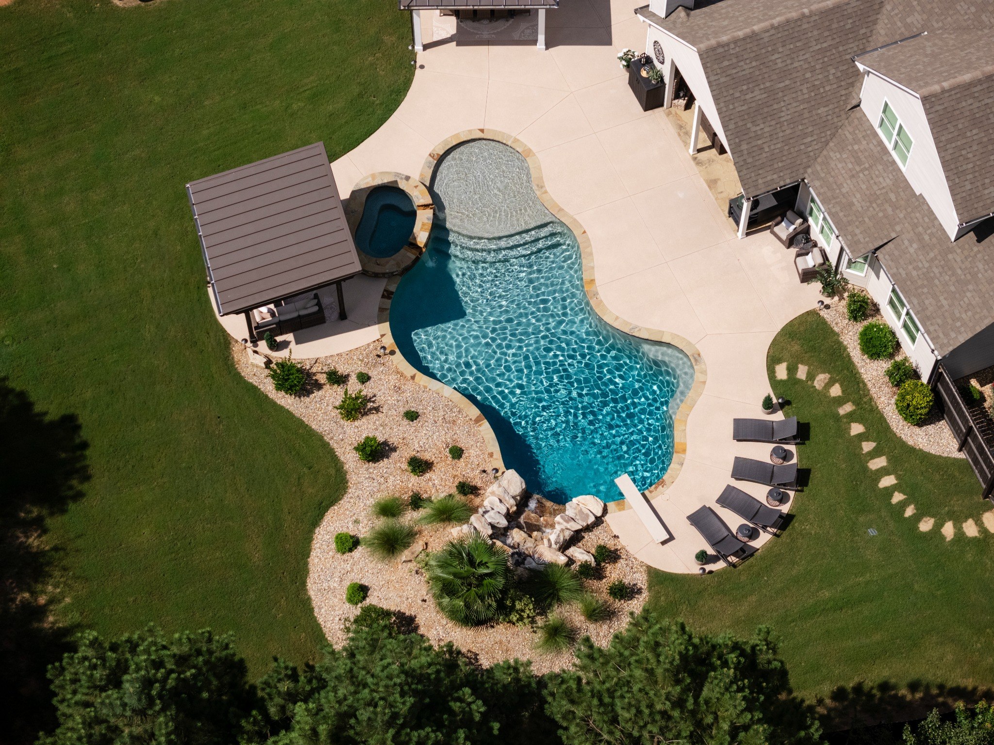 Aerial view of freeform pool and backyard